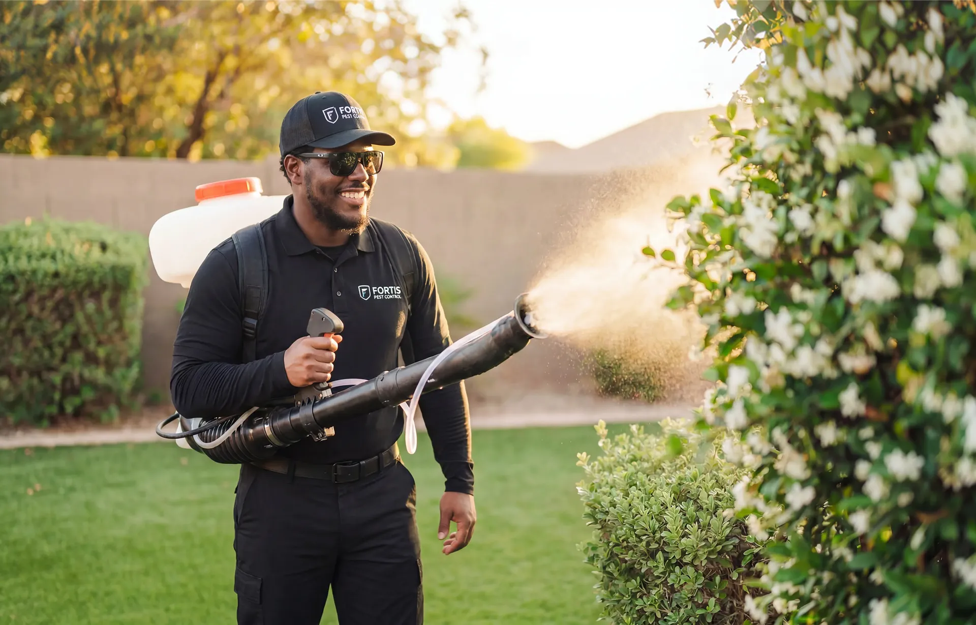 A Fortis Pest Control technician in branded uniform, ready to start a Central Valley service visit.